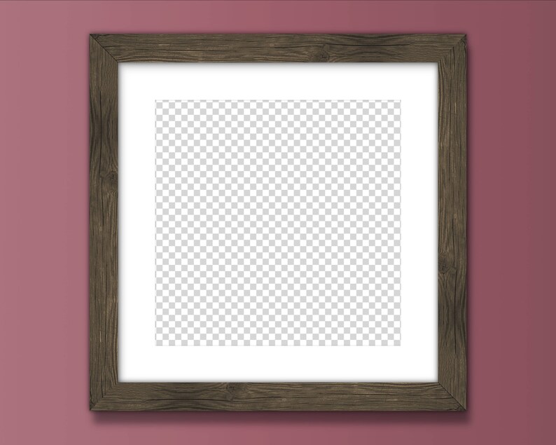 May include: A brown wooden picture frame with a white mount and a clear, transparent background. The frame is hanging on a pink wall.