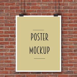 May include: A poster mockup with the words "POSTER MOCKUP" in black font, hanging against a red brick wall. The poster is a light tan colour and is held by two black binder clips.