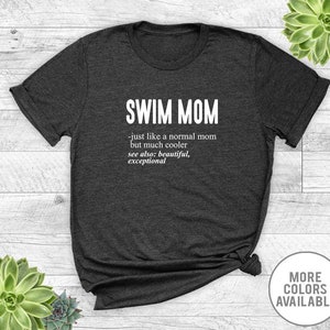 May include: Dark gray t-shirt with white text that reads "SWIM MOM - just like a normal mom but much cooler see also: beautiful, exceptional".