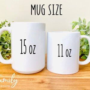 May include: Two white ceramic mugs with black text. The larger mug is 15 oz and the smaller mug is 11 oz.