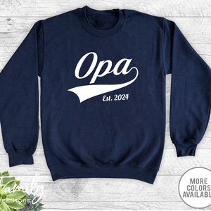 May include: Navy blue sweatshirt with white text that reads " Opa Est. 2024" in a vintage baseball style font.