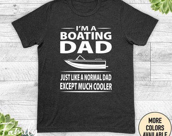 May include: A dark gray t-shirt with white text that reads "I'm a Boating Dad. Just like a normal dad except much cooler."  A white silhouette of a boat is above the text.