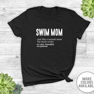 May include: Black t-shirt with white text that reads "SWIM MOM - just like a normal mom but much cooler see also: beautiful, exceptional".
