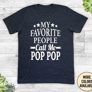 May include: Dark blue t-shirt with white text that reads "My favorite people call me Pop Pop".