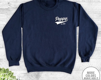 May include: Navy blue sweatshirt with a white graphic that says "Pappy Est. 2022" in a vintage baseball style font.