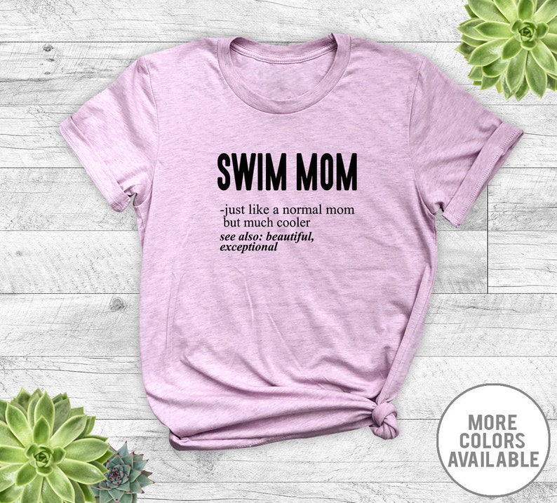 May include: A light purple t-shirt with the text "SWIM MOM - just like a normal mom but much cooler see also: beautiful, exceptional" printed in black.