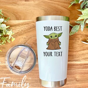 Op de afbeelding: Een witte roestvrijstalen tumbler met een groen cartoonfiguur en de tekst "Yoda Best" en "Your Text". De tumbler heeft een doorzichtig deksel met een schuifregelaar.