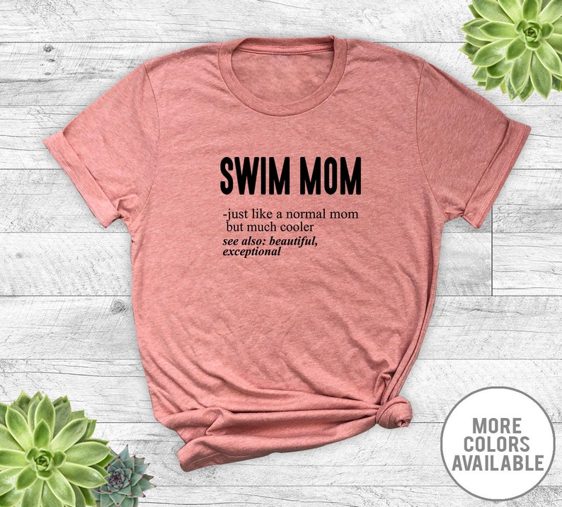 May include: A pink t-shirt with the text "SWIM MOM - just like a normal mom but much cooler see also: beautiful, exceptional" printed in black.