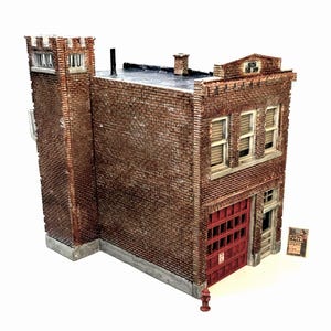May include: A detailed model of a brick fire station with a red fire truck door, a black roof, and a sign that reads "Fire Station No. 1".
