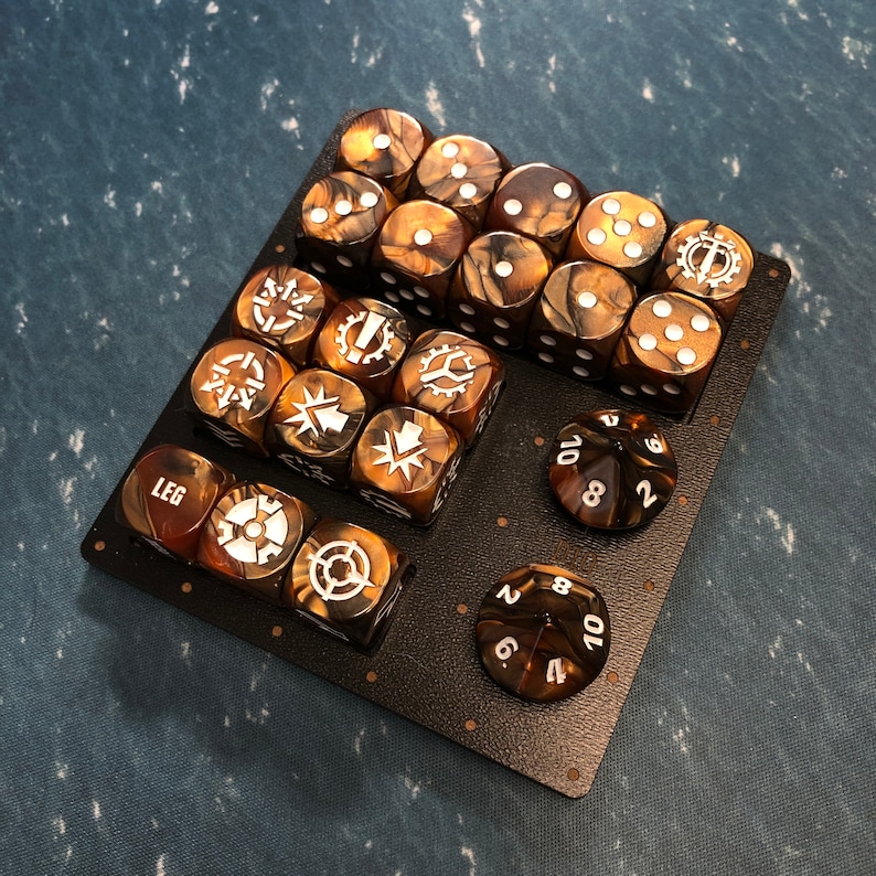 May include: A set of 20 brown and gold dice with white markings. The dice are arranged in a grid pattern on a black surface. The dice have different symbols and numbers on each side.