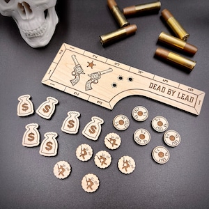 May include: A wooden game board with the text "Dead by Lead 1" and a ruler marked with numbers 1 through 6. The board has two pistols and a star printed on it. There are also several wooden tokens with dollar signs and numbers printed on them.