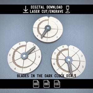 May include: Three wooden clock dials with laser-cut details. Each dial features a dark-colored hand and numbers around the perimeter. The text "BLADES IN THE DARK CLOCK DIALS" is visible. The image also includes the text "DIGITAL DOWNLOAD LASER CUT/ENGRAVE".