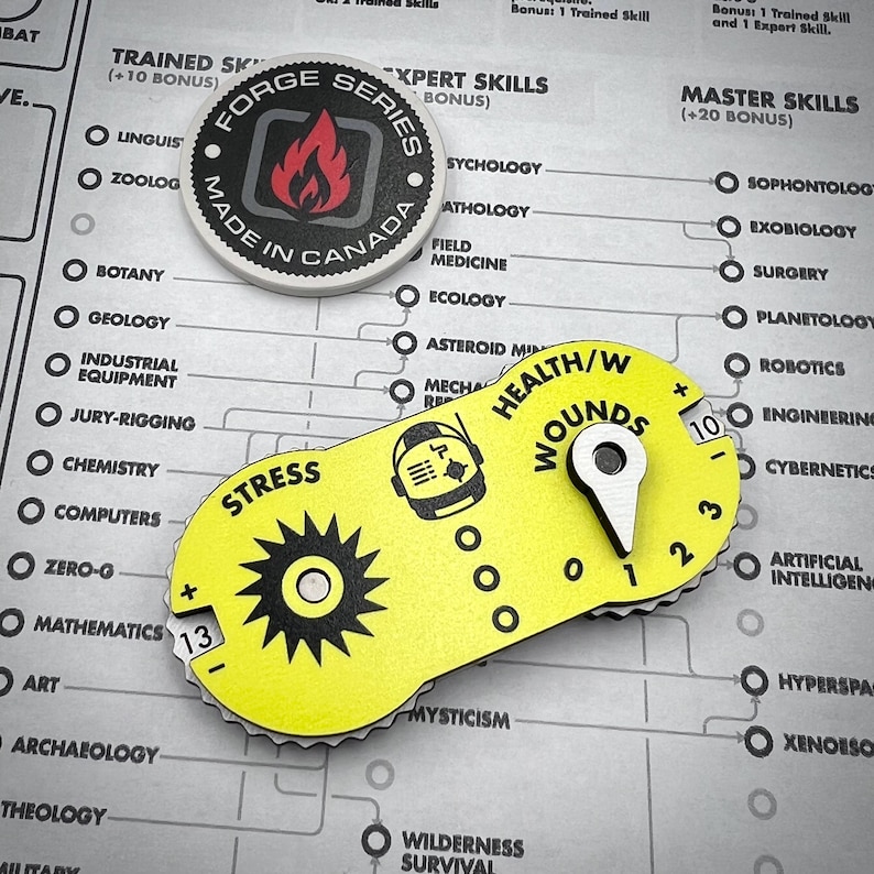 Puede incluir: Un contador de juego ovalado amarillo con un dial de estr&eacute;s negro en forma de engranaje que muestra 13, un dial de salud y heridas con un puntero met&aacute;lico en 1 y un icono de casco. Arriba hay una ficha redonda Forge Series Made in Canada.