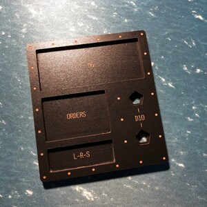 May include: Black wooden game tray with compartments labelled "D6", "ORDERS", "L-R-S", and "D10".