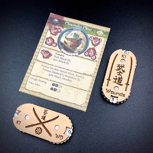 May include: A wooden game piece featuring a samurai warrior design. The piece has a wound tracker with a maximum of 3 wounds. The piece also has a Ki tracker with a maximum of 4 Ki. The piece is labelled "武道" which is Japanese for "The Way of the Warrior".