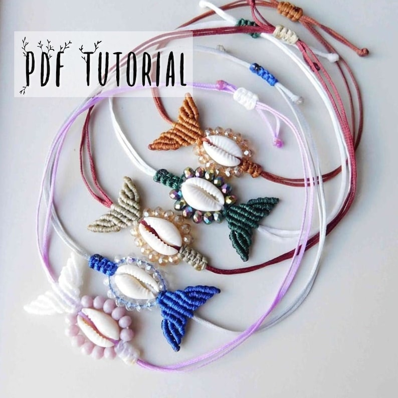 May include: Five colorful bracelets with a shell and crystal bead design. Each bracelet features a knotted fishtail pattern and a different color of thread. The bracelets are arranged in a circle on a white surface.  PDF TUTORIAL is written in the top left corner of the image.