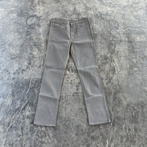 May include: A pair of gray straight-leg jeans. The jeans have a classic five-pocket design and a button fly.