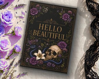 May include: A rectangular print featuring the text HELLO BEAUTIFUL in gold lettering, centered above a human skull, a white lily, and a blue snake, all surrounded by purple roses and dark foliage on a black background with a decorative border.
