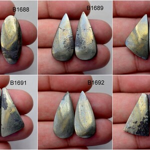 May include: Six pairs of cabochon gemstone pairs, each pair is a different shape and size. The gemstones are a mix of gold and black colours. The pairs are labelled B1688, B1689, B1690, B1691, B1692, and B1693.