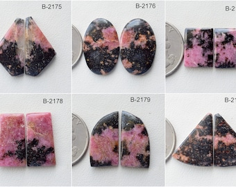 Puede incluir: Seis pares de piedras preciosas cabujón de color rosa y negro, cada par está etiquetado con un código único, B-2175 a B-2180.