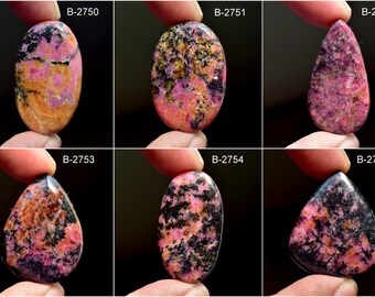 May include: Six pink and black cabochon gemstones, each with a unique pattern. The gemstones are labeled with the numbers B-2750 through B-2755.