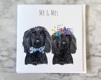 May include: A square greeting card with the text "MR & MRS" above a watercolor illustration of two black dogs. One dog wears a blue polka dot bow tie, and the other wears a floral crown. The card is on a white background.
