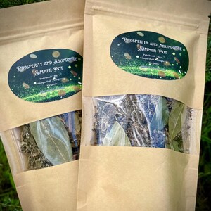 May include: Two brown paper bags with a clear window showing dried herbs inside. The bags have labels that say "Prosperity and Abundance Simmer Pot" with a list of ingredients: Patchouli, Bay, Cinquefoil, and Myristica. The labels are on a sparkly background.