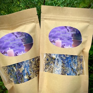 May include: Two brown paper bags with clear windows, each containing a blend of dried herbs and flowers. The bags are labeled "Peace and Tranquility Simmer Pot" with a list of ingredients including lavender, chamomile, blue cornflower, and dragon's blood.