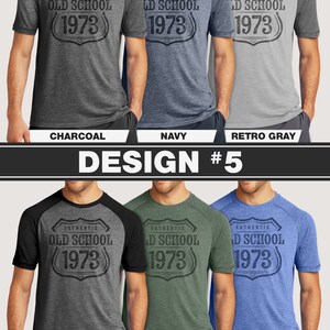 May include: A collection of six short-sleeved t-shirts in various colors, each featuring a shield-shaped graphic with the text "AUTHENTIC OLD SCHOOL 1973". Colors include charcoal, navy, retro gray, retro black, green, and royal.