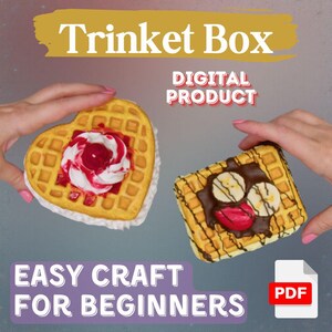 May include: A heart-shaped and square-shaped waffle trinket box with decorative toppings. The heart-shaped waffle has a cherry and whipped cream topping. The square waffle has a chocolate, banana, and strawberry topping. The image includes the text "Trinket Box", "Digital Product", and "Easy Craft for Beginners".