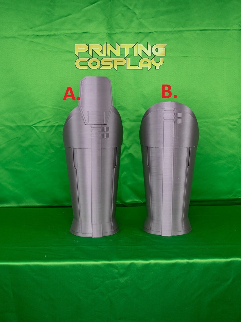 May include: Two 3D printed grey plastic leg armour pieces, labelled A and B, for cosplay. The armour pieces are designed with a textured surface and raised details.