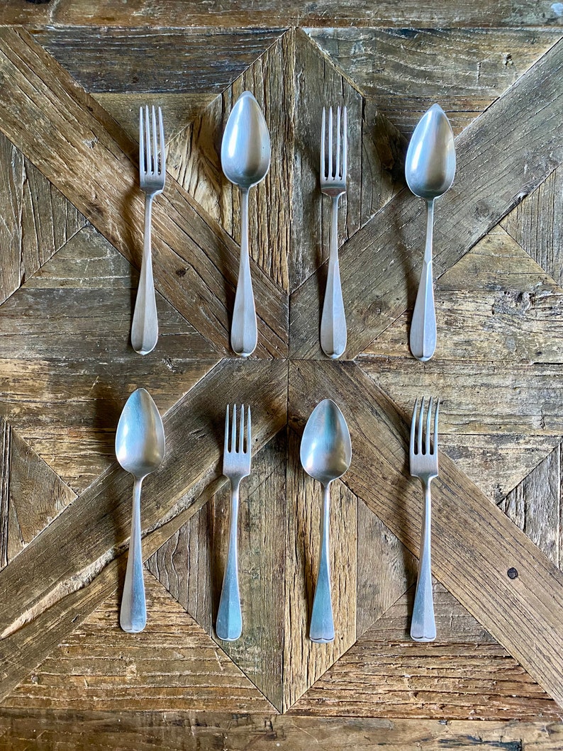 Set of four shops pairs of silver spoons and forks