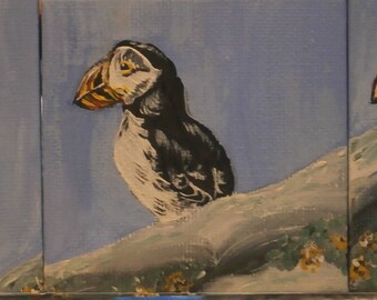 An original acrylic triptych painting of puffins on a rock