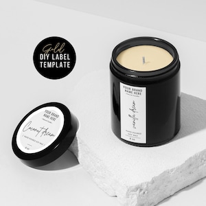 May include: Two black glass candle jars with white labels. The candle on the left is labeled "Coconut Dream" and the candle on the right is labeled "Vanilla Dream". Both candles are hand-poured soy wax and are 8 oz.