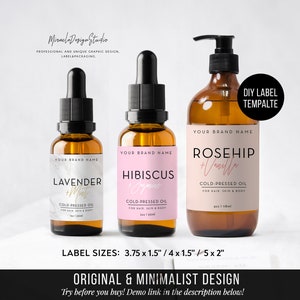 May include: Three amber glass bottles with labels for essential oils. The labels are pink and white with gold lettering. The labels read "Rosehip + Vanilla", "Hibiscus + Jasmine", and "Lavender + Mint". The bottles are on a white background. The text "DIY Label Template" is in the top right corner.