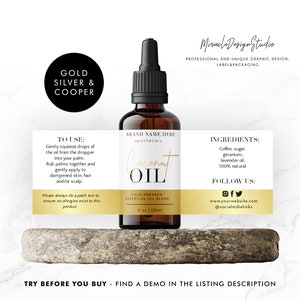 May include: A brown glass bottle of coconut oil with a black dropper, set against a white background. The label reads "Coconut Oil, Cold Pressed Essential Oil Blend." Ingredients include coffee, sugar, geranium, and lavender oil.