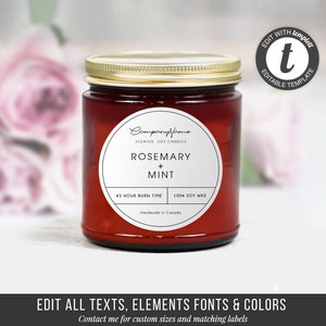May include: A red glass candle jar with a white label that says "Companyffame Scented Soy Candles Rosemary + Mint 45 Hour Burn Time 100% Soy Wax Handmade in Canada".