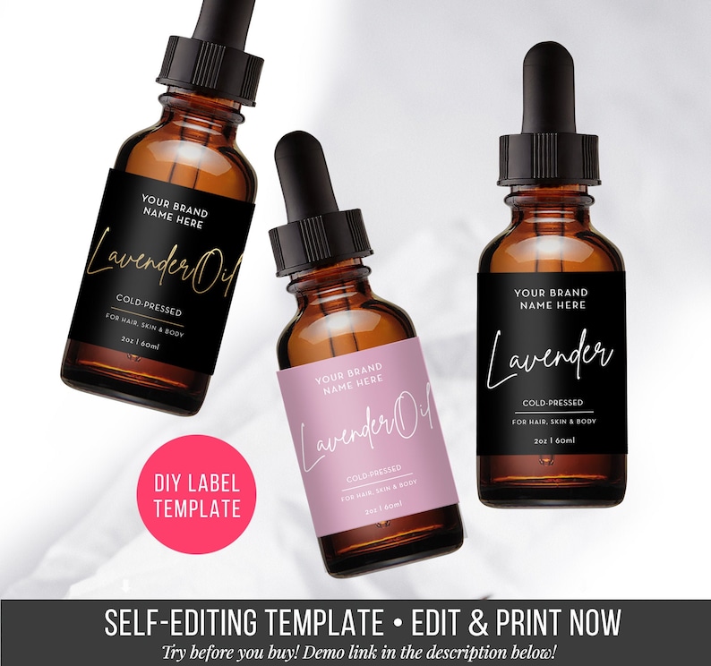 Puede incluir: Tres botellas de vidrio &aacute;mbar con goteros y etiquetas. Las etiquetas son negras con texto blanco y dicen "Your Brand Name Here" y "Lavender Oil" o "Lavender". Las etiquetas tambi&eacute;n dicen "Cold-Pressed" y "For Hair, Skin & Body". Las botellas est&aacute;n sobre un fondo blanco.
