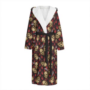 May include: A black hooded robe with a white sherpa lining. The robe has a repeating pattern of a hockey mask with a bloody handprint and a knife.