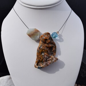 Hand carved Opalized Petrified Wood Leopard, Amazonite , Swarovski bead, Black titanium wire. Sterling silver lobster clasp w/2" extender