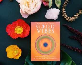 May include: A book titled "Good Vibes" by Shaman Isabella Stoloff. The book cover features a colourful mandala design and the text "Positive Affirmation Cards, A 33-Card Deck and Guidebook".