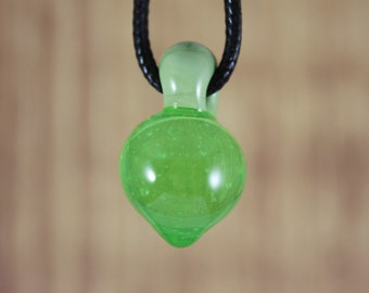May include: A green glass pendant with a teardrop shape and a black cord.