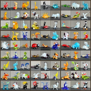 May include: A white ceramic mug with a black handle and the text "But First, Coffee" in a black, bold font. The mug is on a white surface.