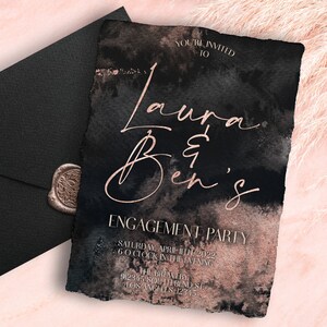 May include: Black and rose gold engagement party invitation with a watercolor background. The invitation reads "You're invited to Laura & Ben's Engagement Party" with the date and time of the party and the location: "The Brewery, 91234 South Bend St, Los Angeles 12345".