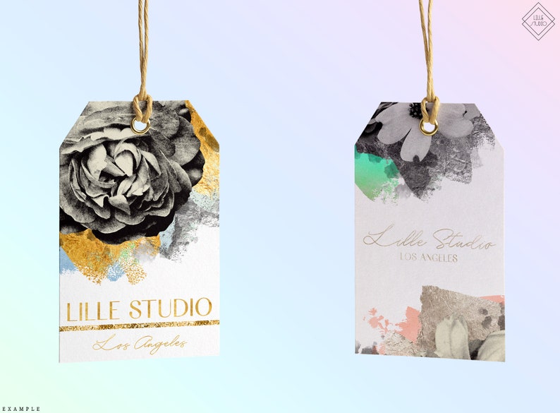 May include: Two white gift tags with gold accents and floral designs. The tag on the left features a black and white rose with gold paint splatters. The tag on the right features a black and white floral design with green and pink paint splatters. Both tags have the text "LILLE STUDIO Los Angeles" printed on them.