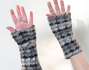 May include: A pair of gray and black fingerless gloves with a textured knit pattern.