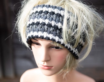 May include: A black and white striped knit headband with a white background and black stripes. The headband is worn on a mannequin with blonde hair.