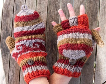 May include: A pair of fingerless gloves with a striped pattern in shades of red, brown, and gray. The gloves have a button on each cuff.