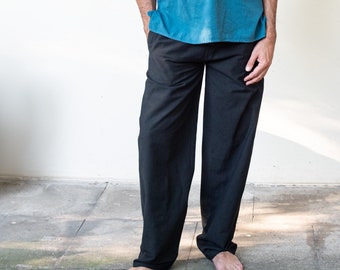 May include: Black wide-leg pants with a relaxed fit. The pants are made of a soft, comfortable fabric.