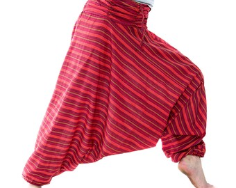 May include: Red striped harem pants with a gathered waistband. The pants have a loose, flowing design and are made of a lightweight fabric. The stripes are a mix of red and gold.